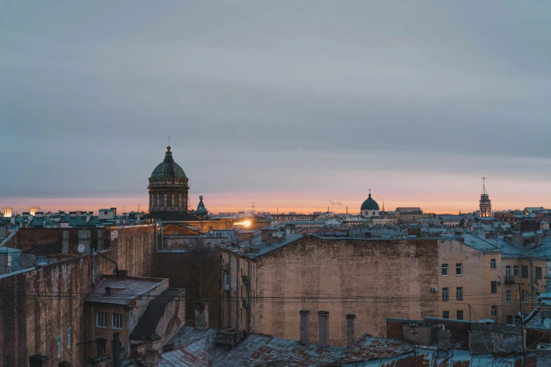 the city skyline has old buildings and a tower in the distance