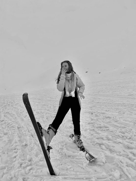 woman leaning against skis and wearing a jacket