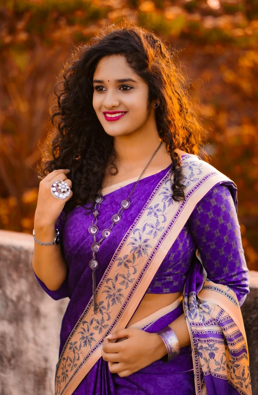 a woman in a purple dress standing on the street with a jewelry set