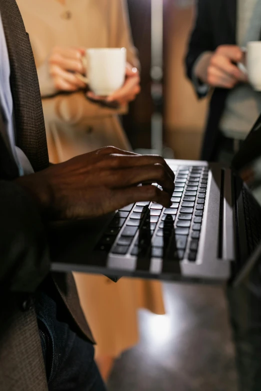 the hands are touching the keyboard on this laptop