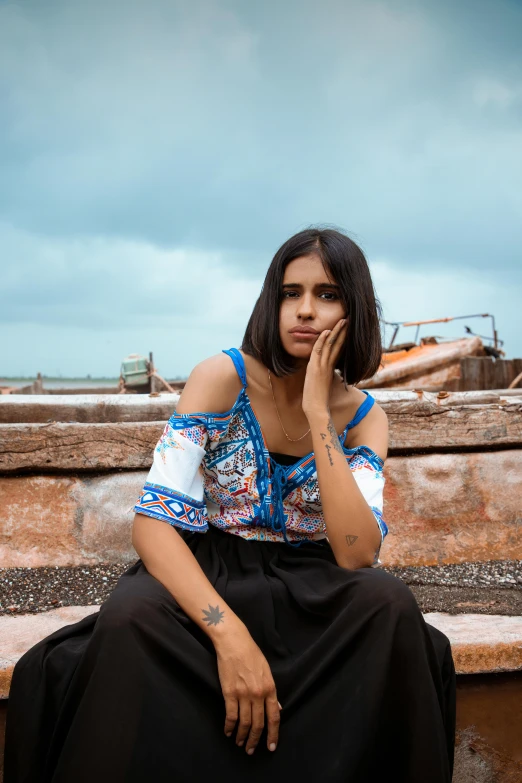 a girl sitting on top of a concrete ledge