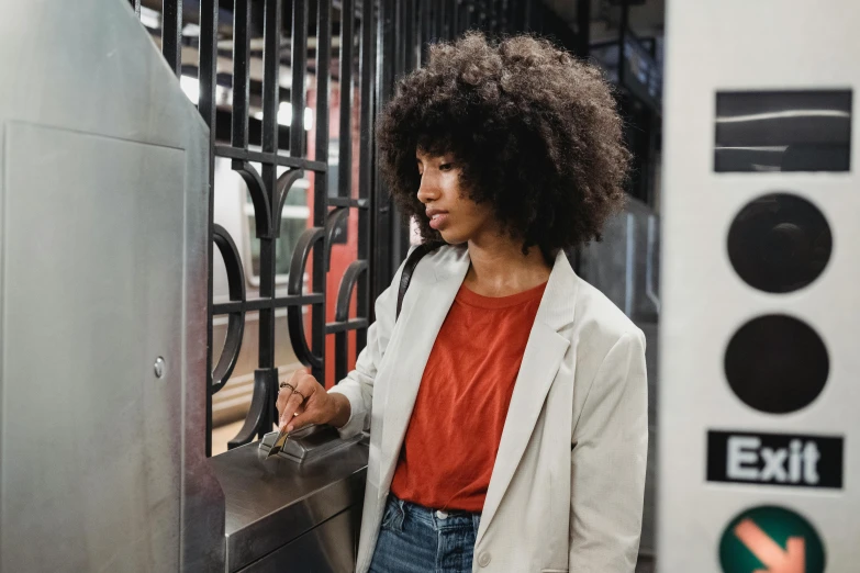 an african american woman uses a handrail to reach the doors