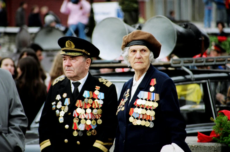 a man and a woman in military attire standing next to each other