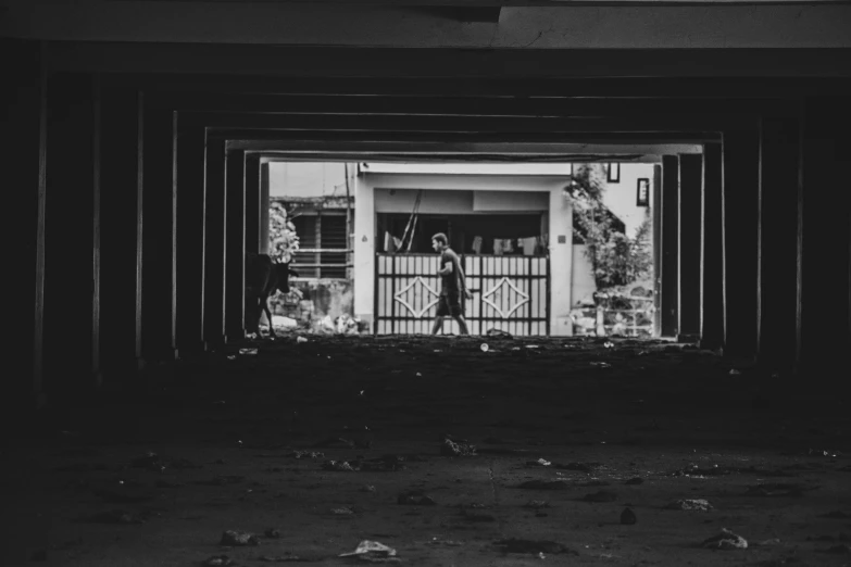 a black and white image of the back door of an abandoned house