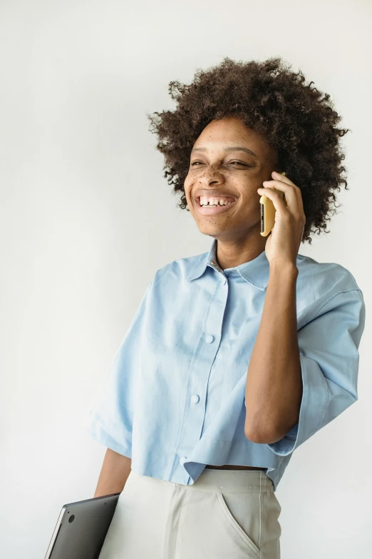 a woman with an afro talking on a cell phone