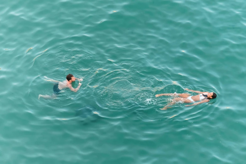 two people swimming in the ocean together