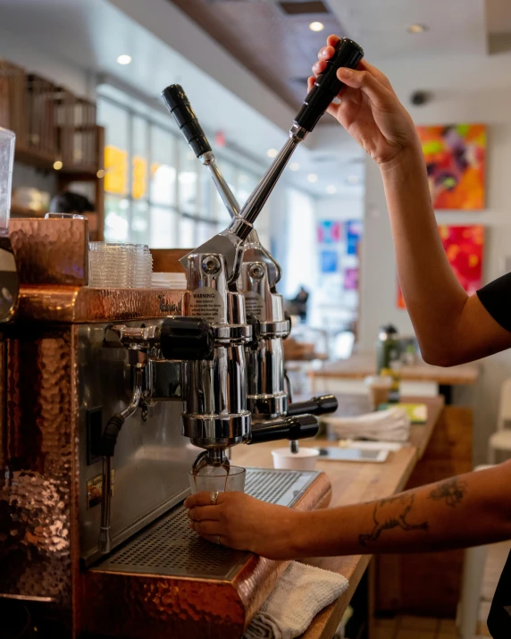 a coffee machine and a person making a cup of coffee