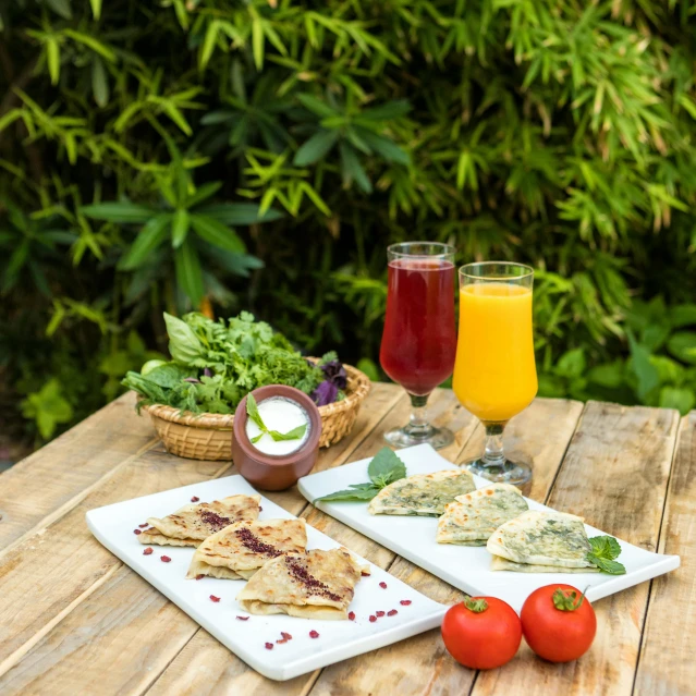 plates of food sit on top of the table with glasses