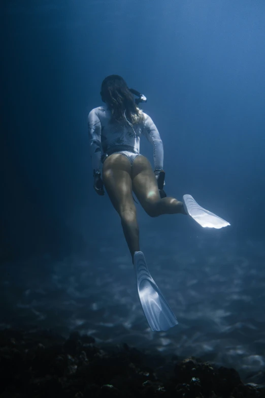 a woman is diving and holding some papers