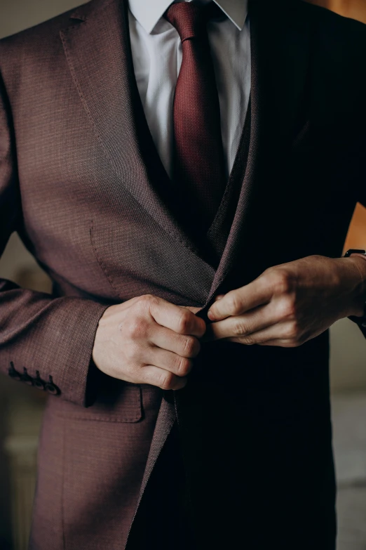 a man wearing a suit with a red tie