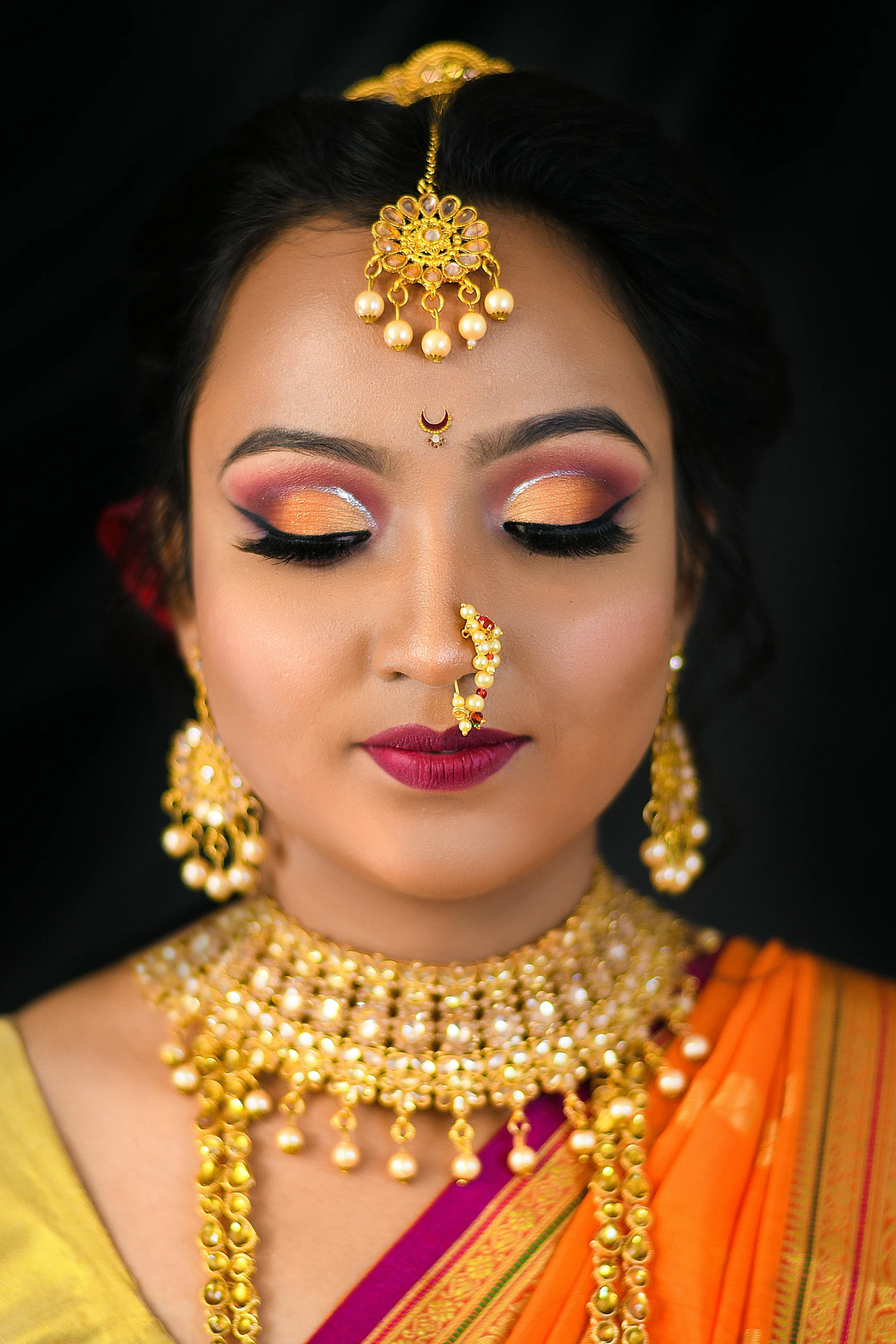 the beautiful indian bride wearing gold jewelry