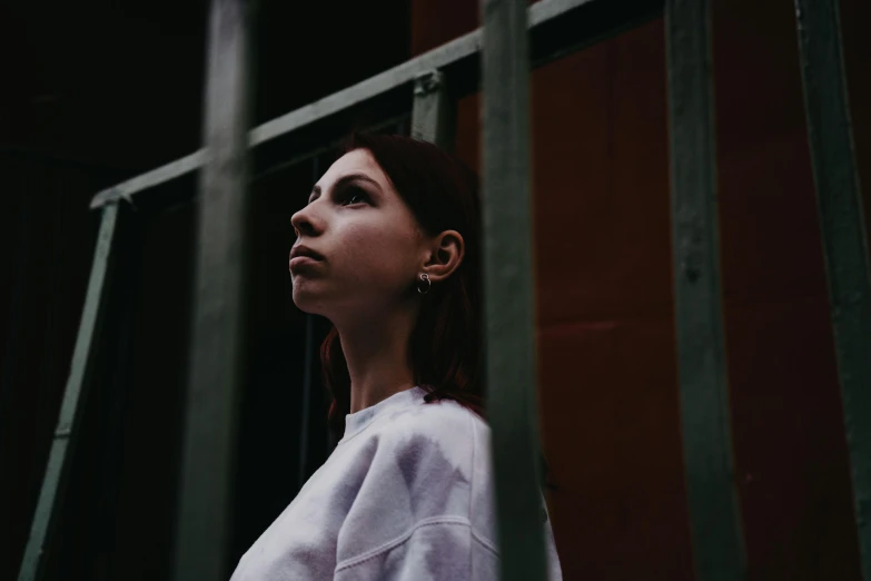 an image of a woman with red hair staring out