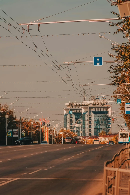 a city street with a blue sign on a clear day