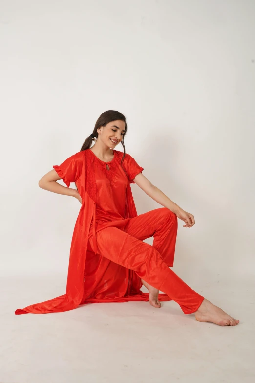 a young woman poses in an orange jumpsuit