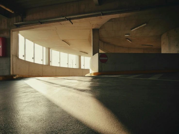 a empty parking garage with sunshine coming through the windows