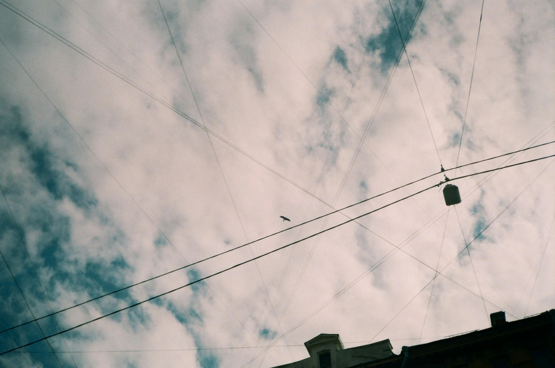 the sky above some telephone wires on a cloudy day
