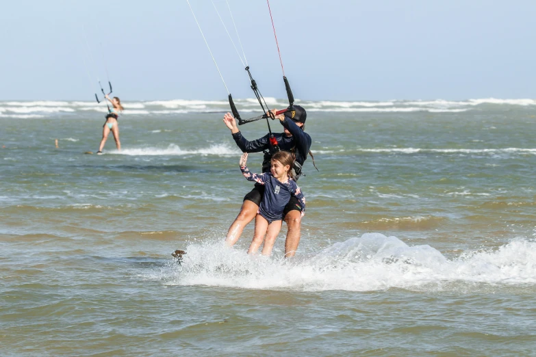 two people are surfing in the ocean together