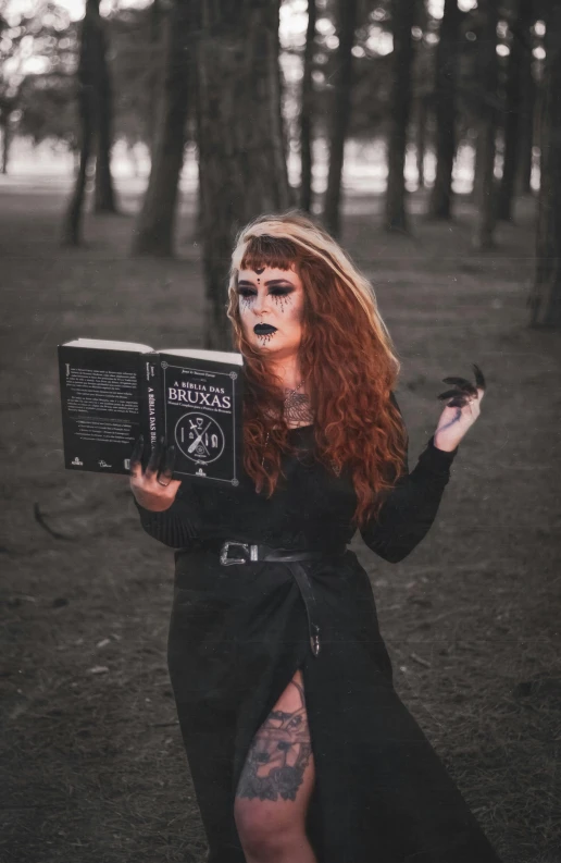 a lady dressed in black is reading a book