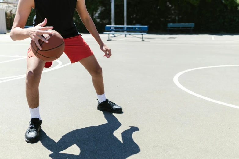 the young man is playing basketball on the court