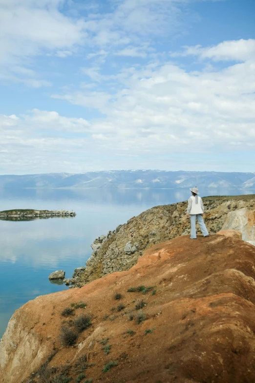 a man standing on the edge of a cliff