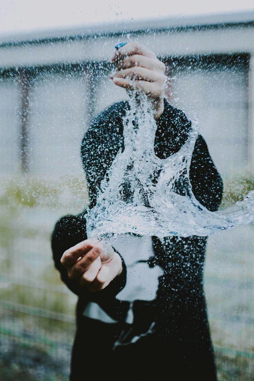 a man in a suit is under the rain