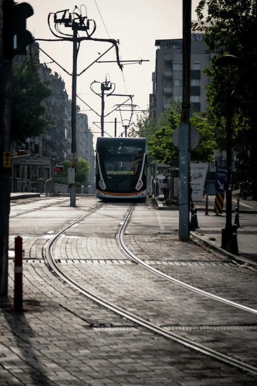 a train going down the track on a city street
