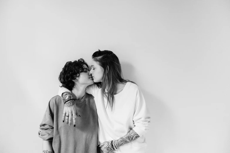 black and white pograph of two girls kissing each other