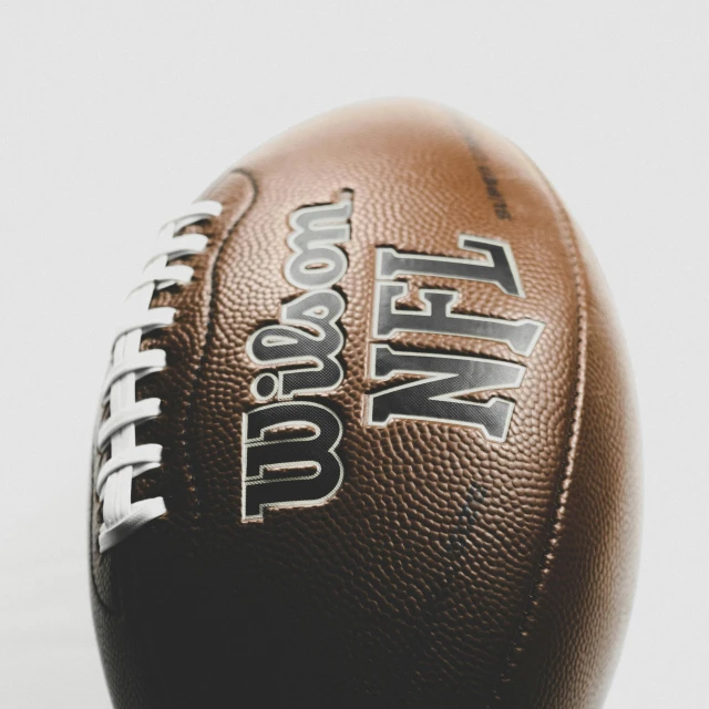 a football sitting on top of a table with the words happy new year in black and white