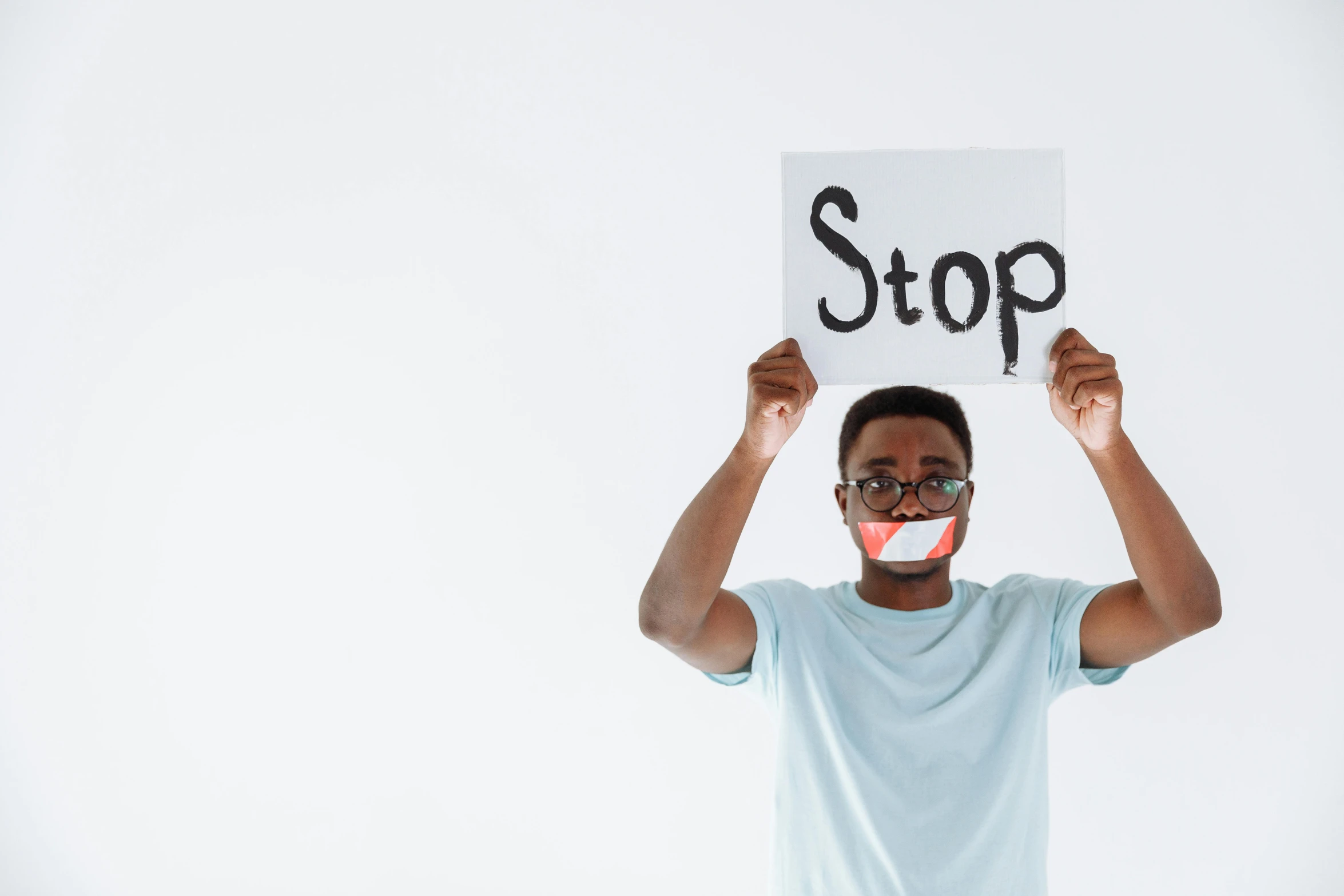 a man holding up a sign that reads stop