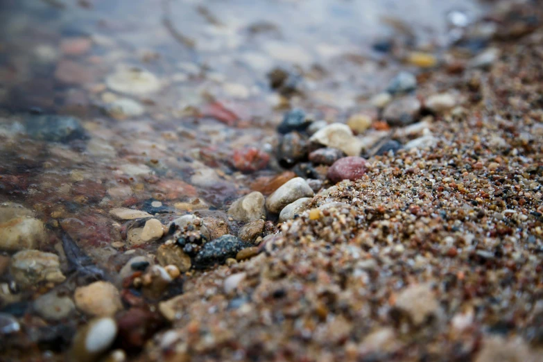 various rocks sitting on top of a beach