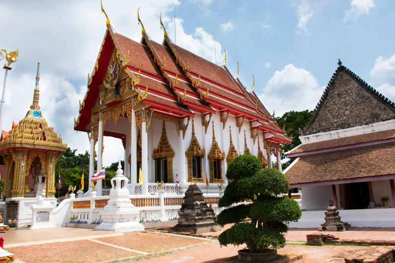 two buildings with golden spires in front of them