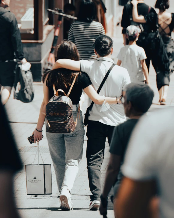 a man and woman walking down a city street