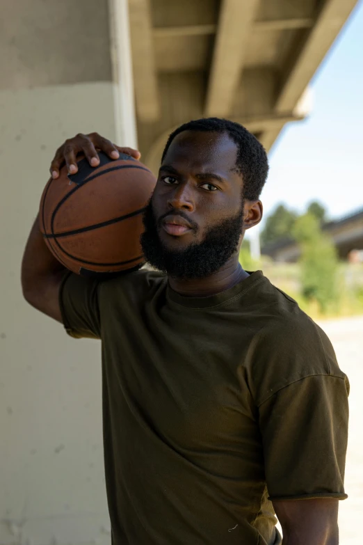 a man standing holding a basketball on a porch