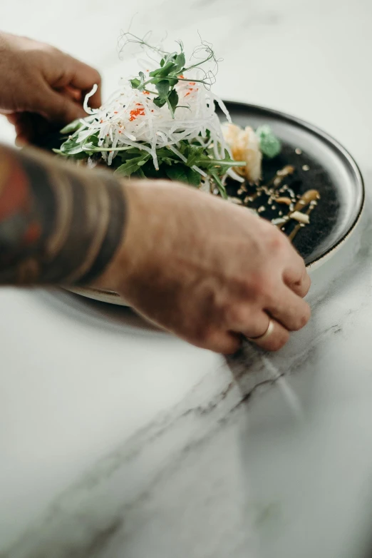 someone is preparing a dish in a small set