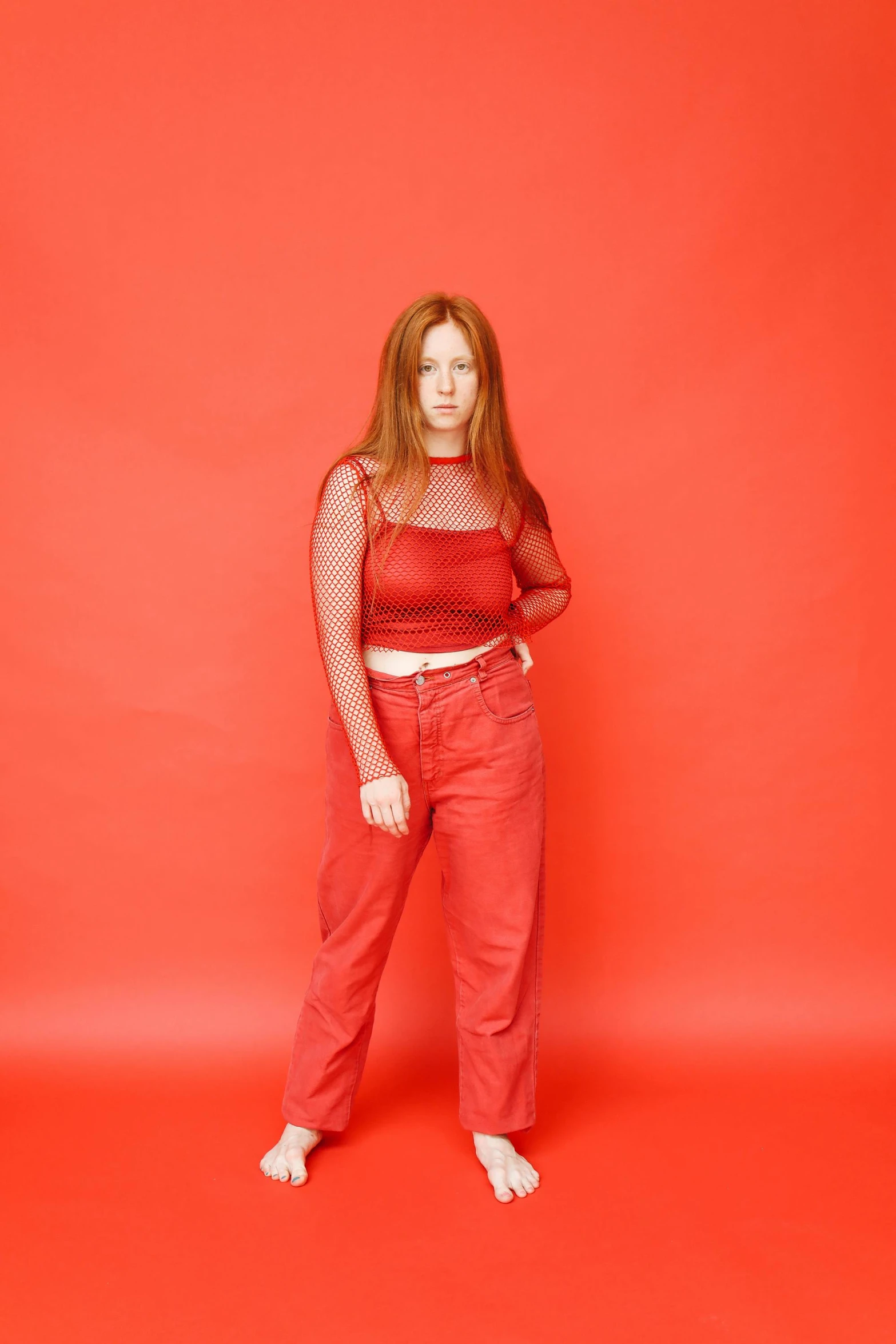 a woman in red pants and a top