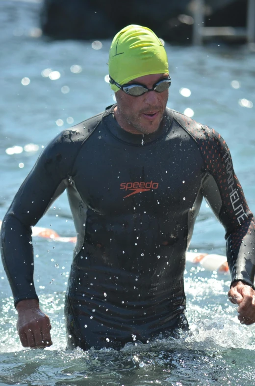 a man with sunglasses is swimming in the water