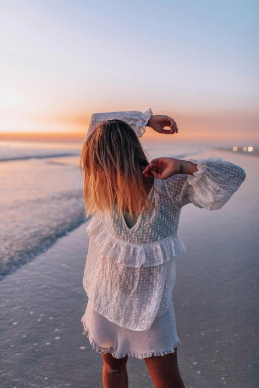 a girl that is standing on some sand