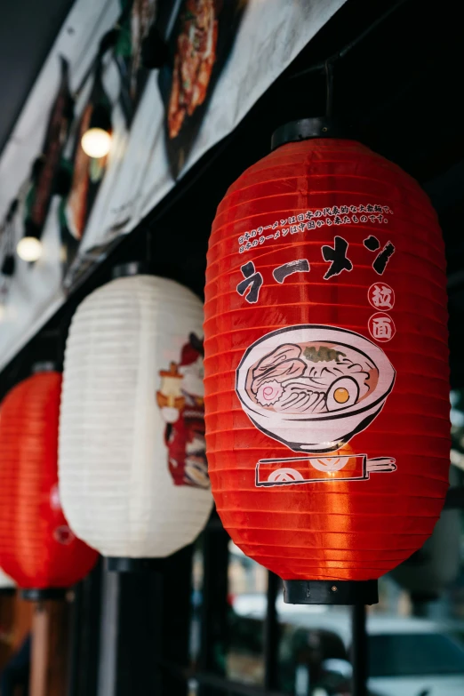 paper lanterns hung from the ceiling with chinese writing