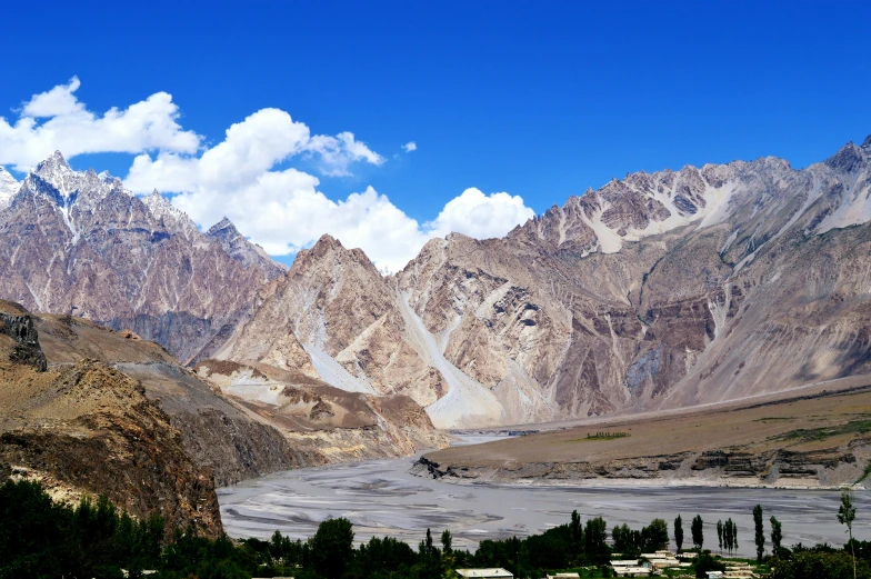 a large valley with a mountain range in the background