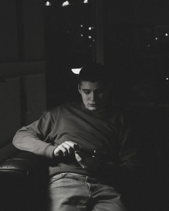 black and white po of a young man holding a controller