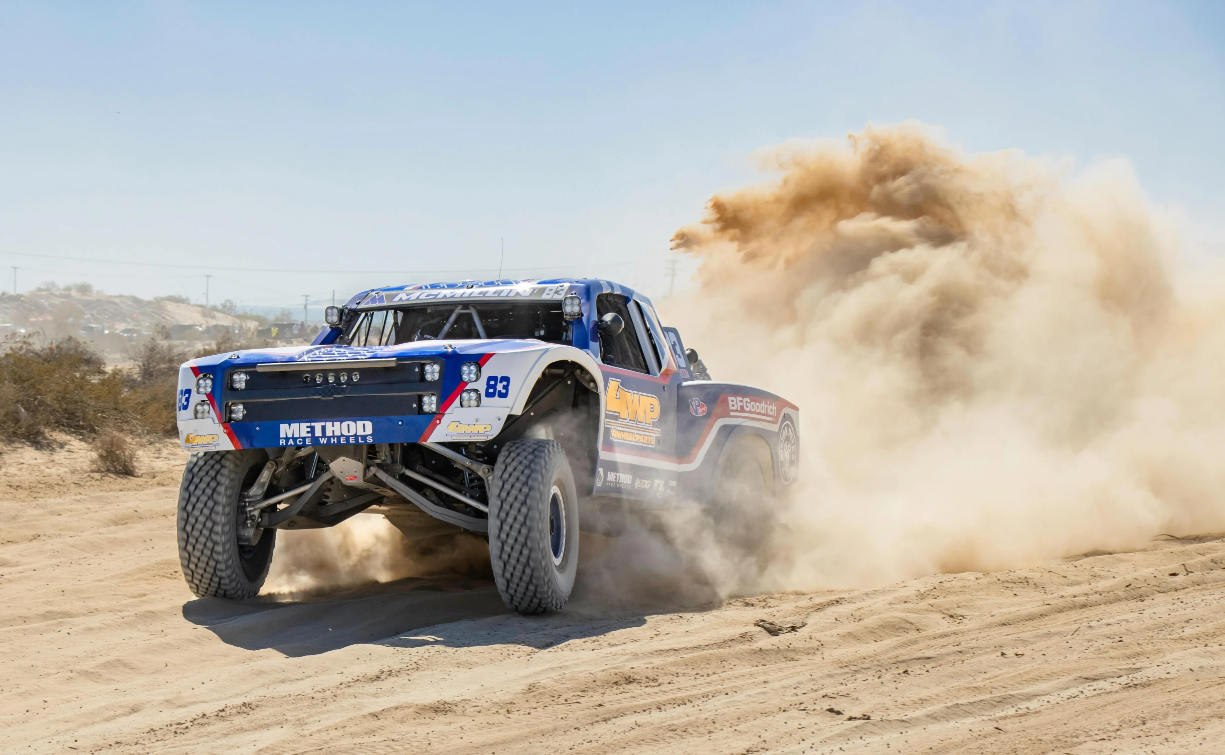 the truck is kicking up dust on the track