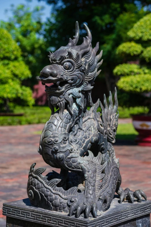 a dragon statue is in the center of a park