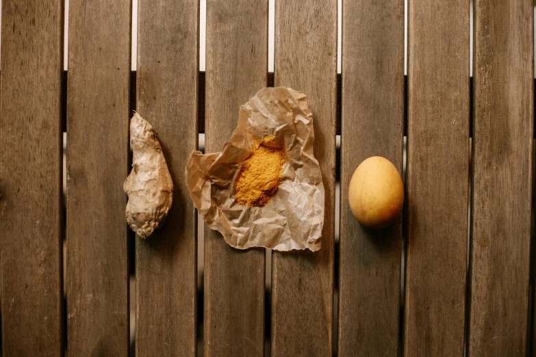 eggs and bread are sitting on top of a wooden table