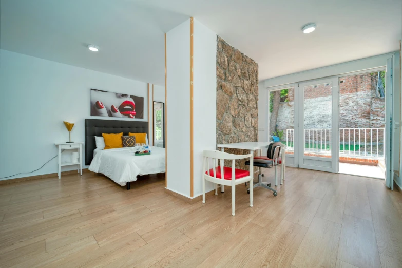 a bedroom with white walls and wooden flooring