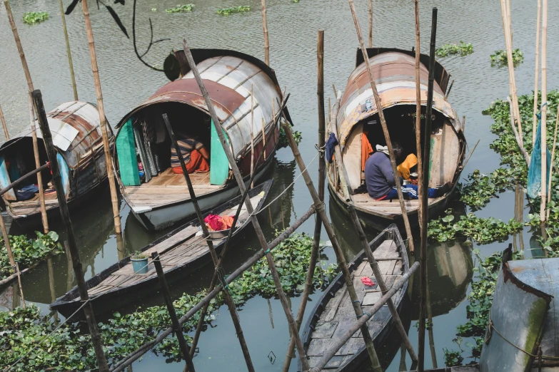 people sitting at a boat dock next to another boat