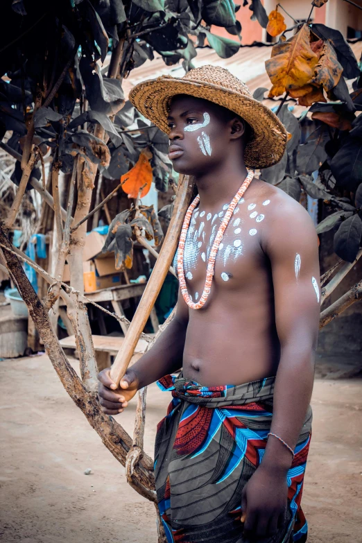 a man standing on the ground with paint all over his body