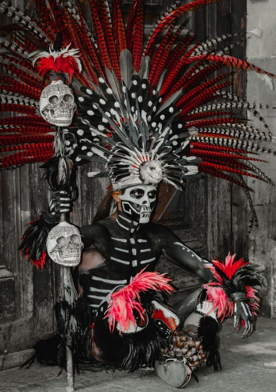 a woman with skull headdress sitting on a chair