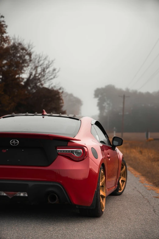 red sports car parked on the side of the road