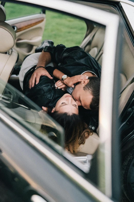 the couple is getting into their car and kissing