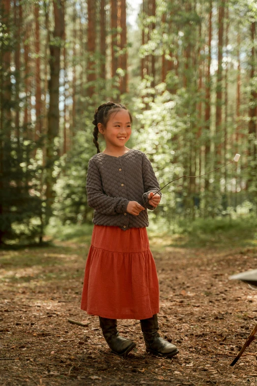 a little girl in a red dress is holding soing